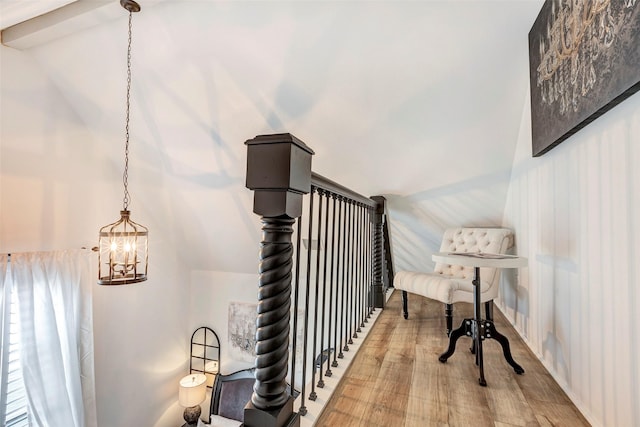 staircase featuring lofted ceiling and wood-type flooring