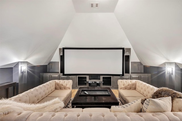 home theater room featuring lofted ceiling