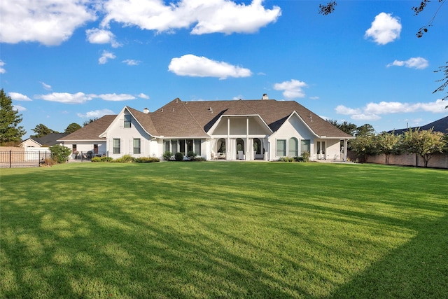 back of house with a lawn