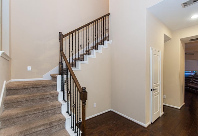 staircase featuring wood-type flooring