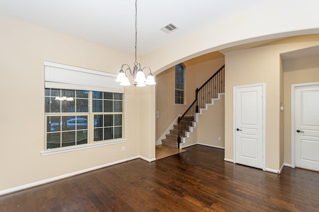 unfurnished dining area with dark hardwood / wood-style floors and a notable chandelier