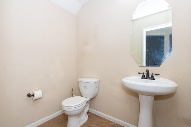 bathroom with toilet and tile patterned flooring