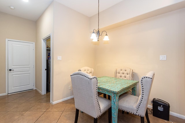 dining room featuring light tile patterned flooring and a notable chandelier