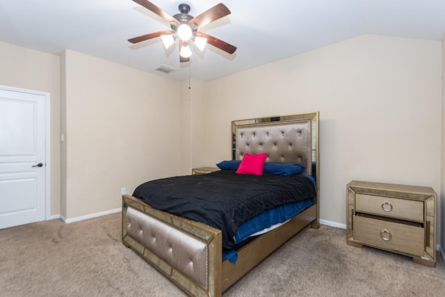 bedroom with vaulted ceiling, light colored carpet, and ceiling fan