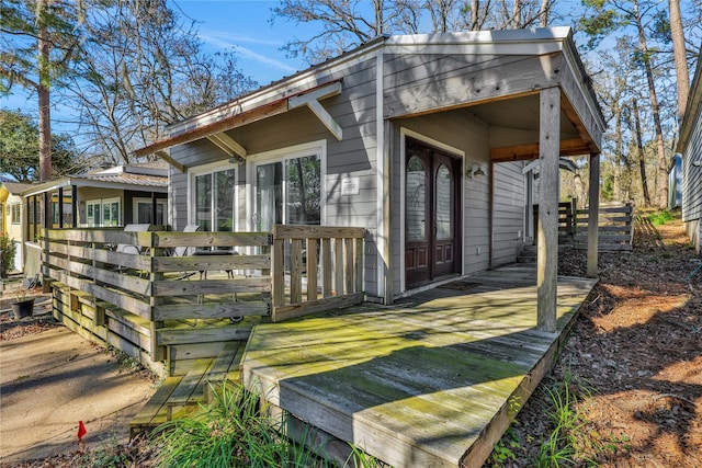 back of house featuring french doors and a deck