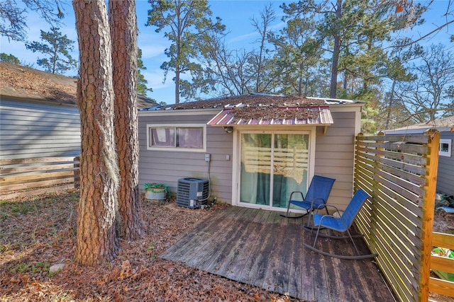 back of house featuring cooling unit and a deck