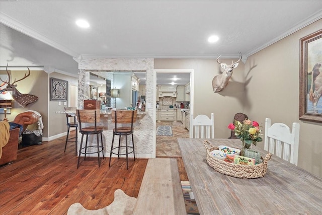 2120 Fm 1406th Rd, Winnie, TX 77665 - dining area with wood finished floors, crown molding, recessed lighting, and baseboards