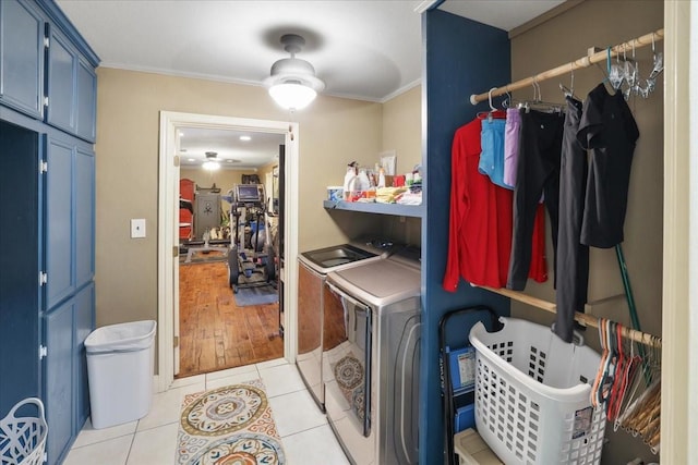 2120 Fm 1406th Rd, Winnie, TX 77665 - laundry area featuring crown molding, light tile patterned flooring, cabinet space, and washing machine and clothes dryer