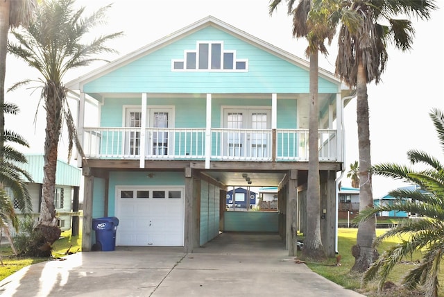 raised beach house with a garage and a carport