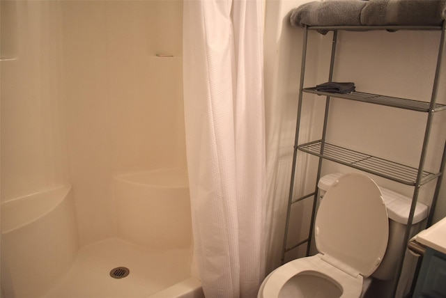 bathroom featuring curtained shower and toilet