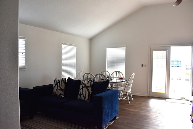 living room with dark wood-type flooring and vaulted ceiling