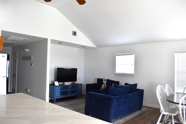 living room with dark wood-type flooring, vaulted ceiling, and ceiling fan