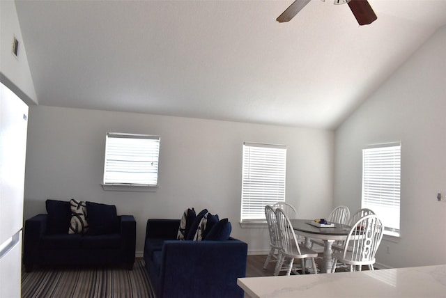 living room featuring dark hardwood / wood-style flooring, lofted ceiling, and ceiling fan