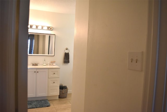 bathroom with vanity, tile patterned flooring, and a textured ceiling