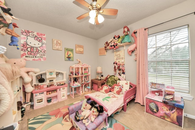 bedroom with a textured ceiling, ceiling fan, and carpet flooring