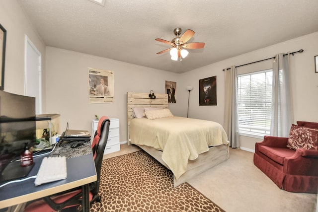 carpeted bedroom with ceiling fan and a textured ceiling