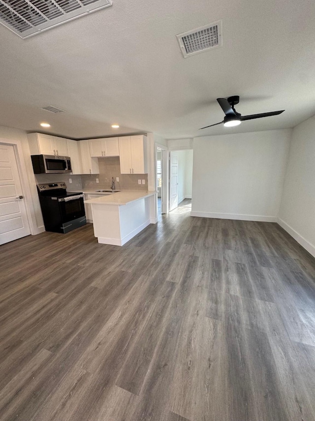 kitchen featuring dark hardwood / wood-style flooring, sink, stainless steel appliances, and white cabinets