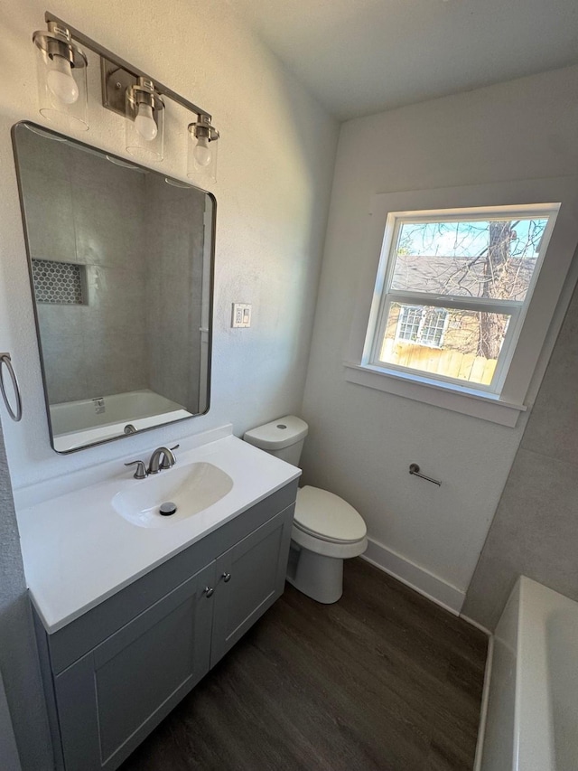 full bathroom featuring shower / bathtub combination, wood-type flooring, toilet, and vanity