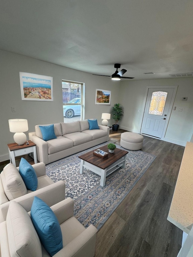 living room with ceiling fan and dark hardwood / wood-style flooring