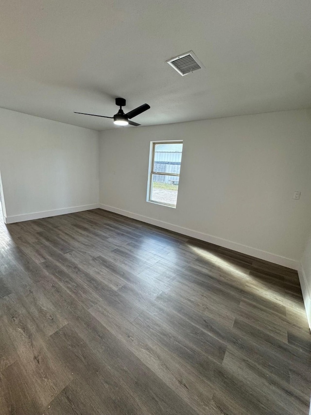 unfurnished room featuring dark hardwood / wood-style floors and ceiling fan