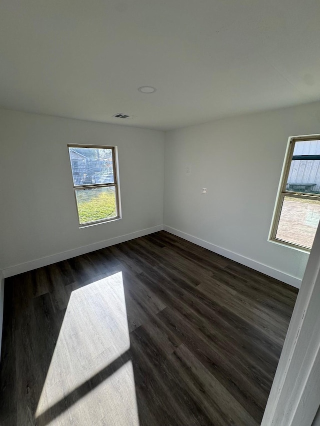 empty room with dark wood-type flooring