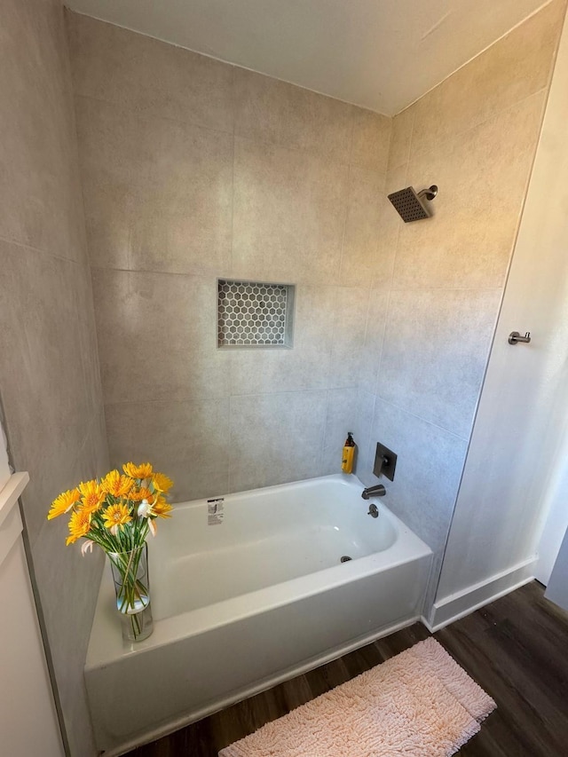 bathroom featuring wood-type flooring and shower / bathtub combination