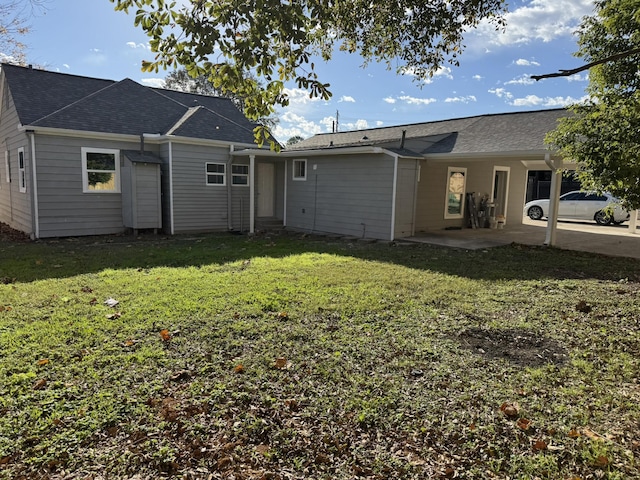 rear view of property featuring a yard and a patio