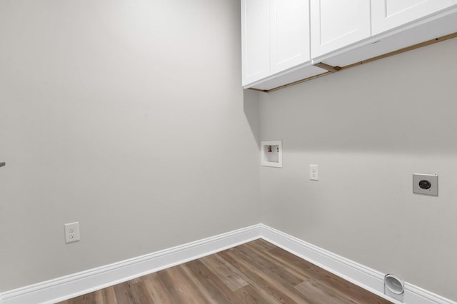 clothes washing area with cabinets, washer hookup, hookup for an electric dryer, and wood-type flooring