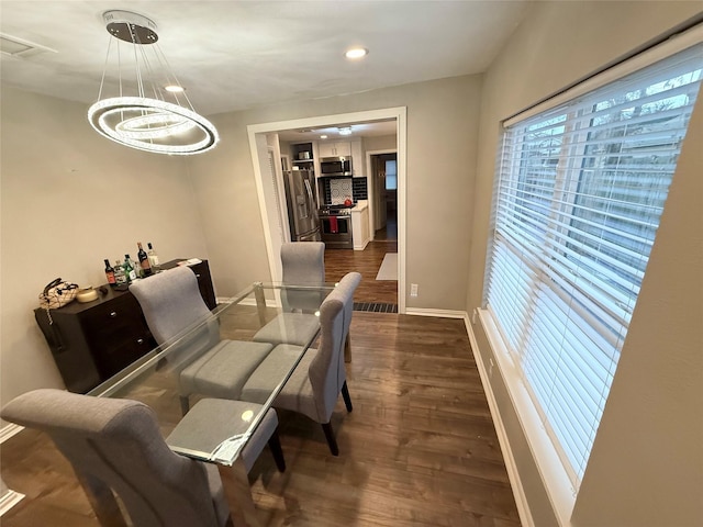 dining space featuring dark wood-type flooring