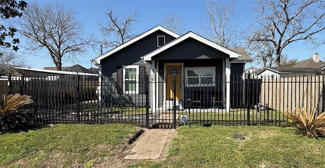 bungalow with a fenced front yard and a front yard