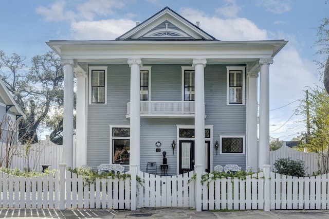 neoclassical home with a balcony and a porch