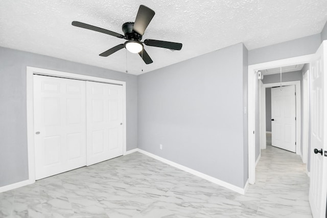 unfurnished bedroom with a textured ceiling, ceiling fan, and a closet