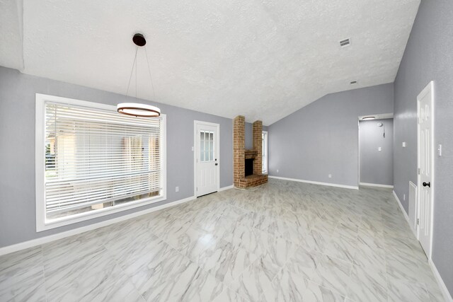 unfurnished living room featuring a fireplace, vaulted ceiling, and a textured ceiling