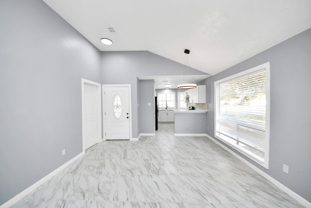 unfurnished living room with lofted ceiling