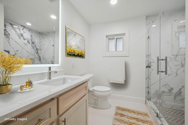 bathroom with vanity, toilet, and a shower with door