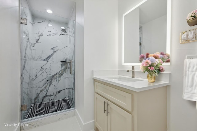 bathroom with a shower with door, vanity, and tile patterned flooring