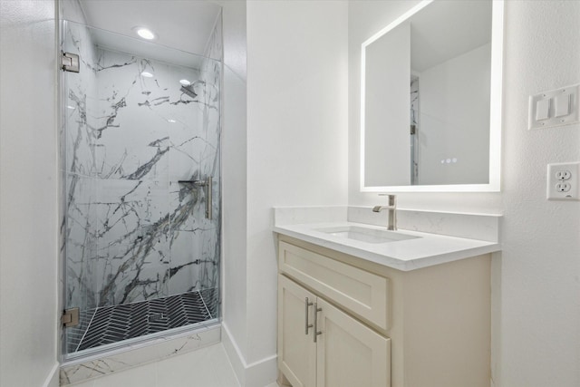 bathroom featuring vanity, tile patterned floors, and tiled shower