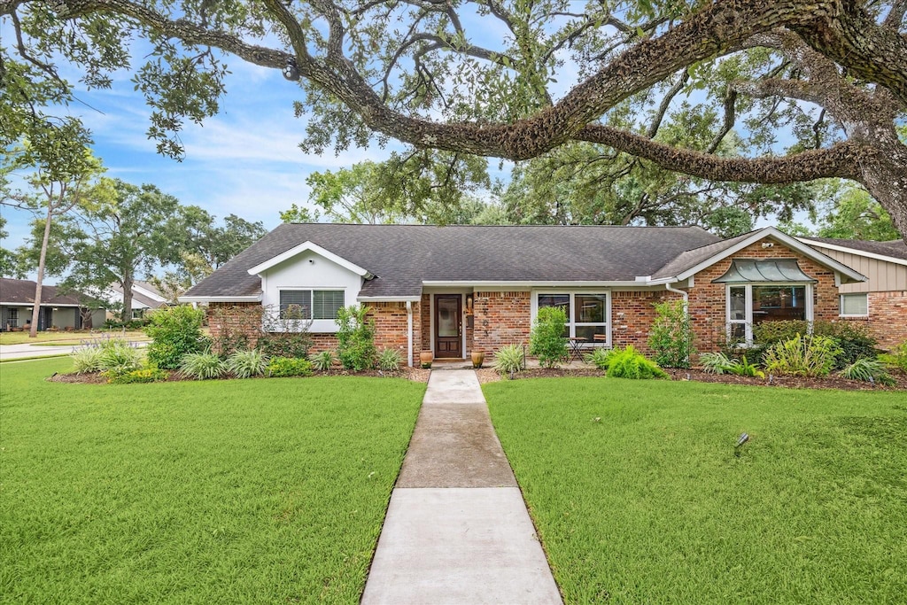 ranch-style home with a front lawn