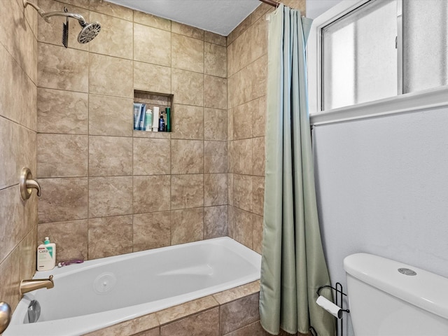 bathroom featuring shower / bath combination with curtain and toilet