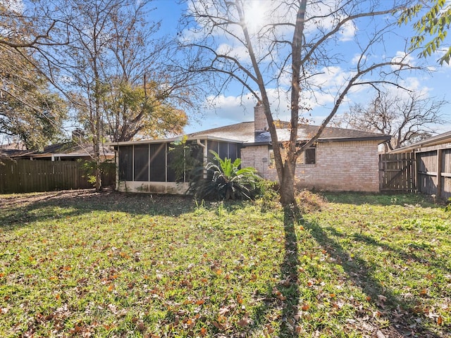 view of yard featuring a sunroom