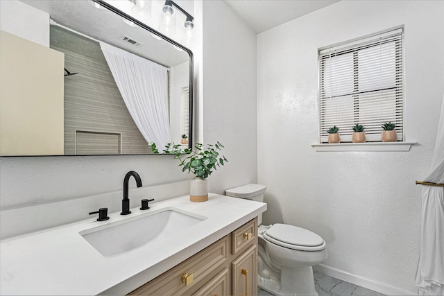 bathroom featuring vanity and toilet