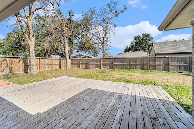 wooden terrace featuring a lawn