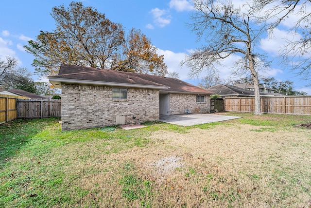 back of property with a patio and a lawn