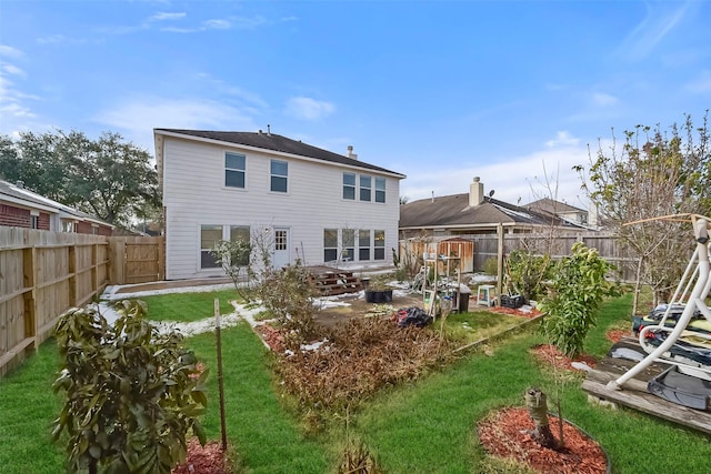 rear view of house featuring a yard and a patio