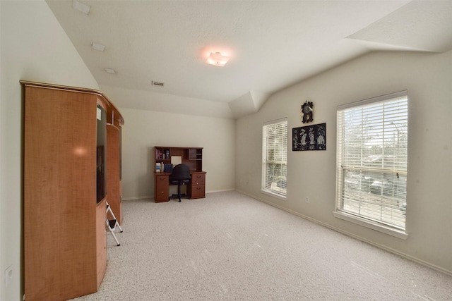 misc room featuring vaulted ceiling and light carpet