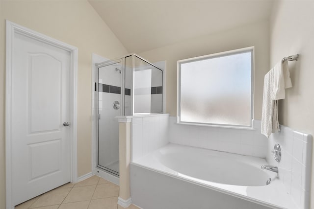 bathroom with lofted ceiling, tile patterned flooring, and separate shower and tub