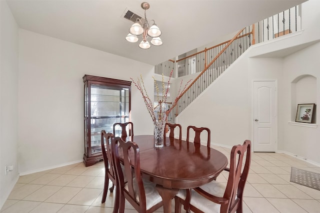 dining room with a notable chandelier and light tile patterned floors