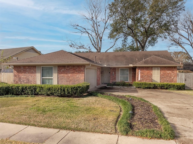 ranch-style home with a garage and a front yard