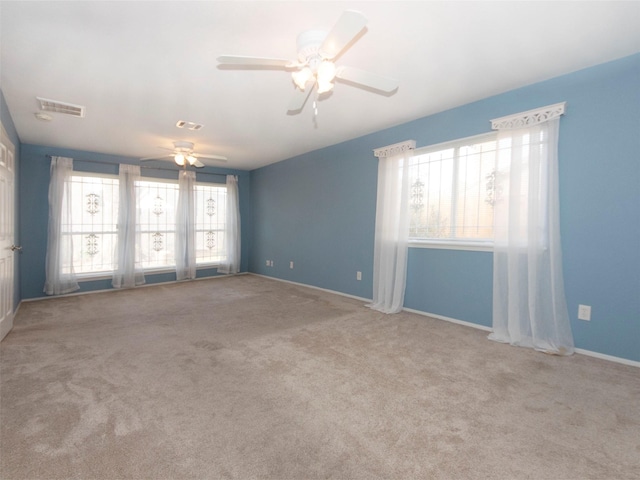 empty room with light colored carpet and ceiling fan