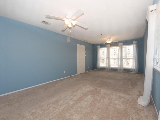 carpeted spare room with ceiling fan